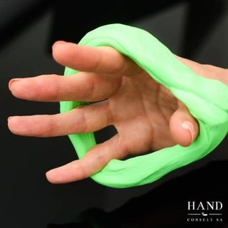 Fingers spreading therapy putty to build strength
